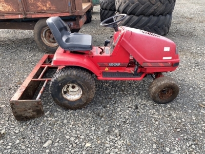 Lawnmower with yard scrapper attachment