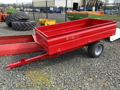 Small tractor tipping trailer