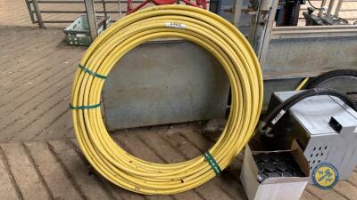 Large roll of yellow pipe