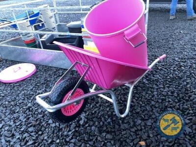 Pink wheelbarrow with pink feed bin